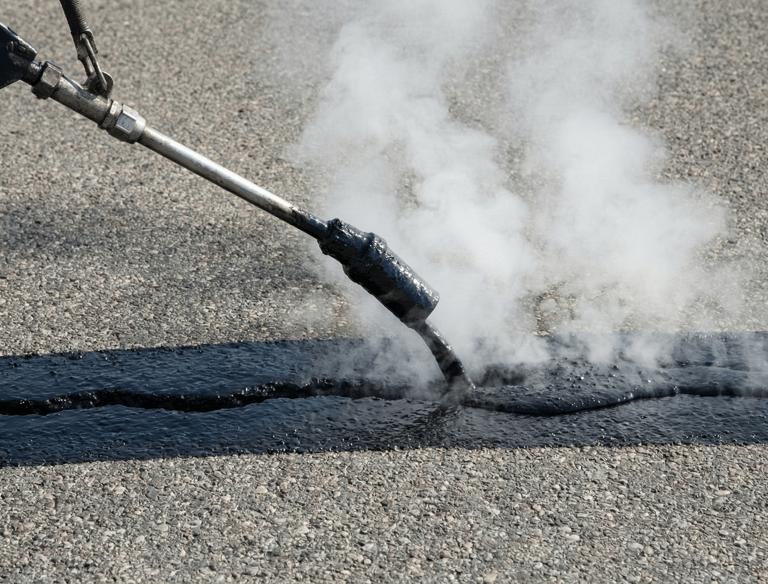 Shows filling a crack with hot tar