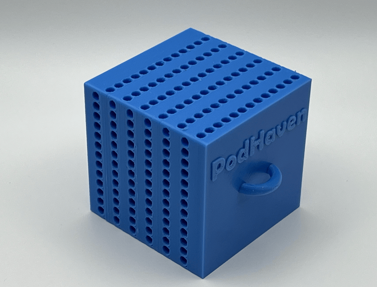Blue 3D printed PodHaven storage cube with small holes for copepods and a ring handle.
