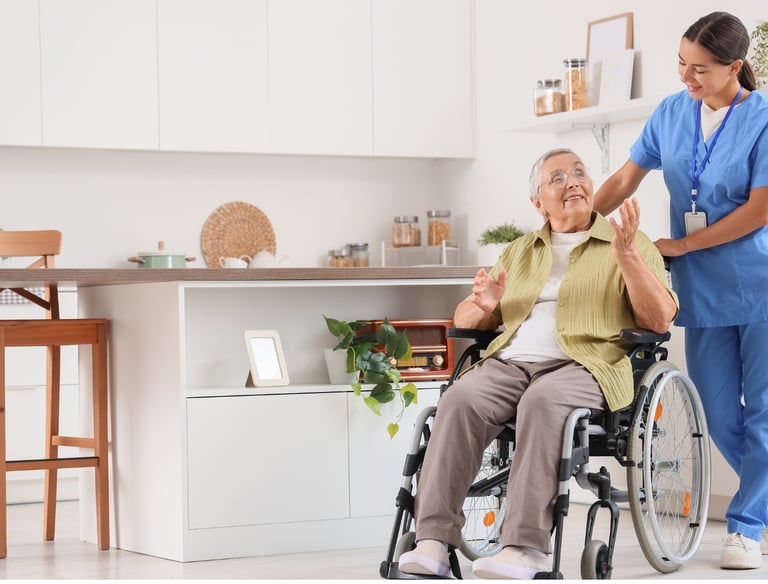 A caregiver pushing an elderly woman patient in her wheel chair