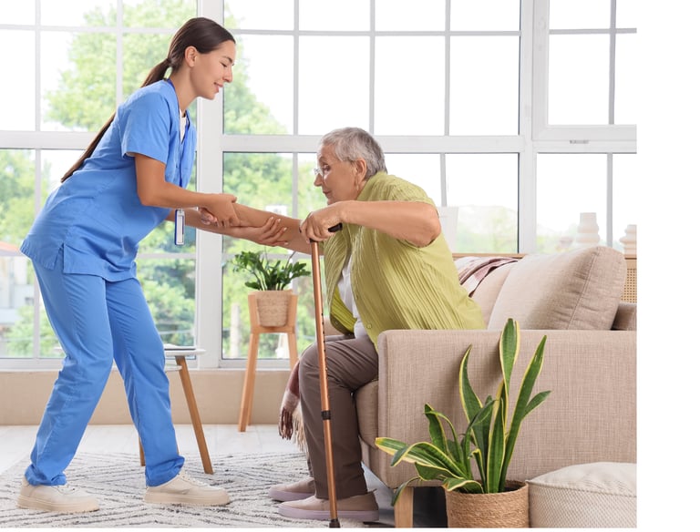 Caregiver helping a female patient to stand up
