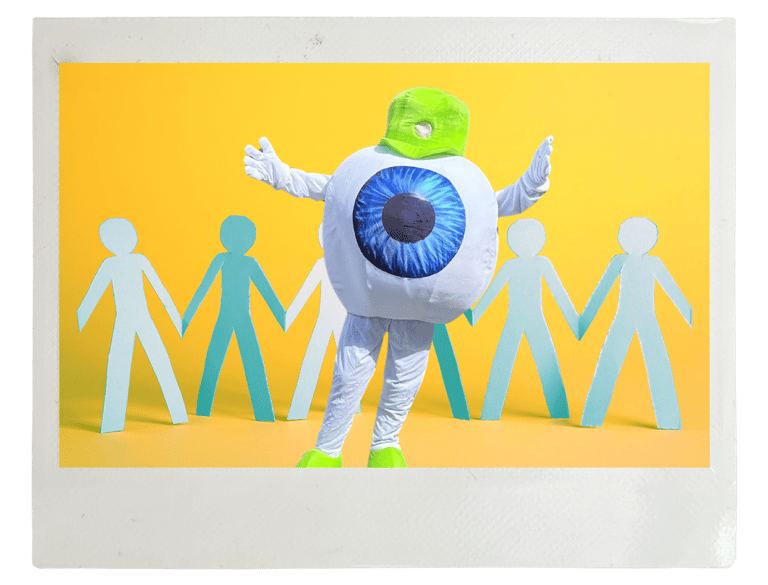 Edge Optics' eyeball mascot standing in front of people cutouts