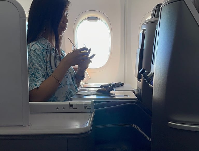 a lady drinking on a business class suite on singapore airlines