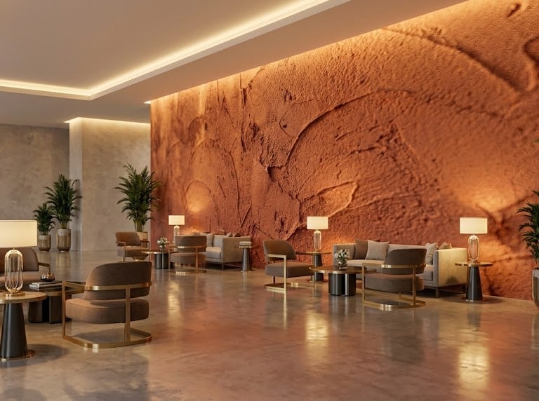 Modern luxury hotel lobby with plastered walls, velvet armchairs, and cozy ambient lighting..