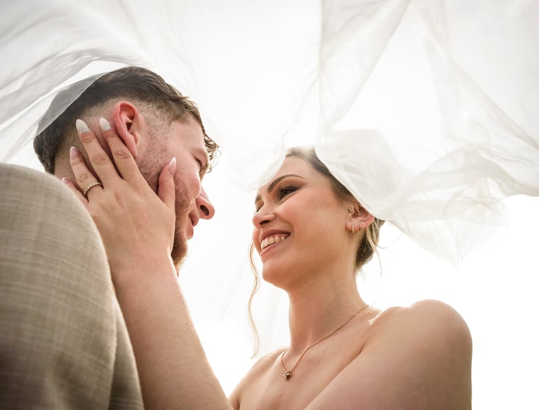 a bride and groom are smiling and laughing