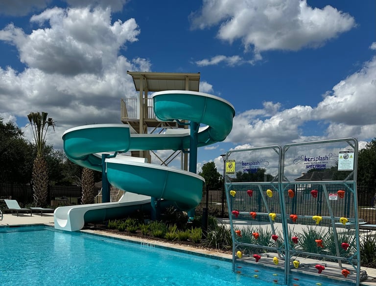 a water slide tower next to a pool