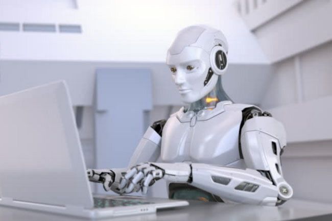a robot is sitting at a desk with a laptop