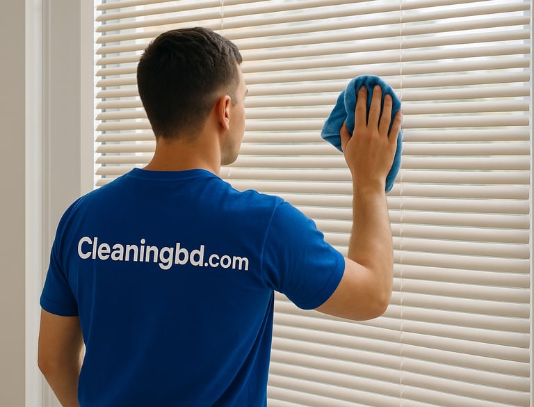 A Man cleaning window a window blinds