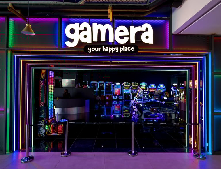a storefront door with a neon - lit sign that says gamera