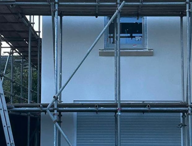 Team applying smooth render to the outside of a residential property.