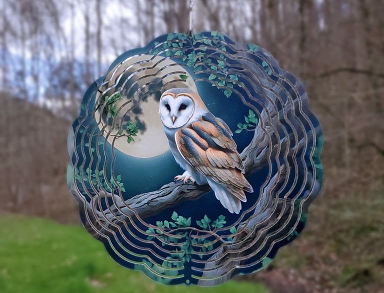 a wind spinner picturing an owl in the moonlight.