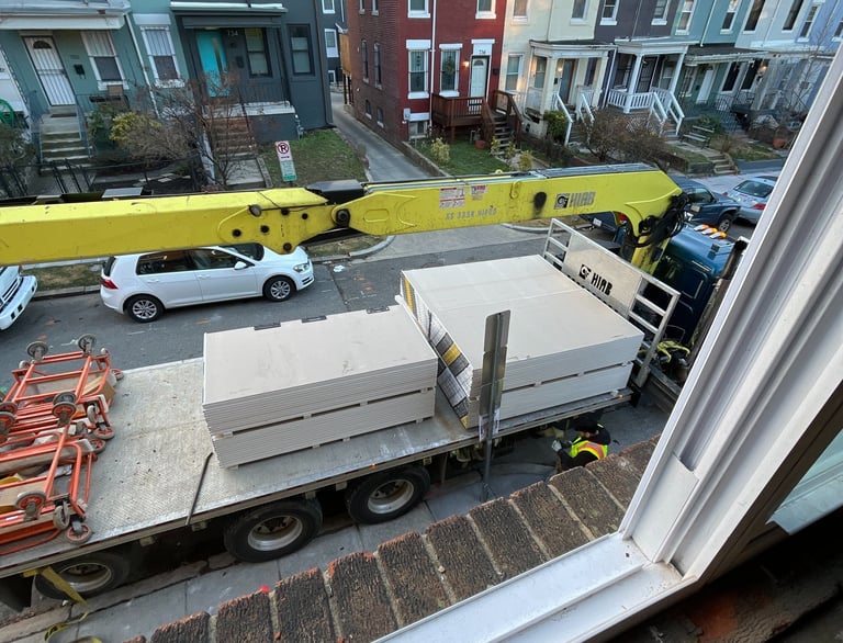 a truck with a trailer parked in front of a house