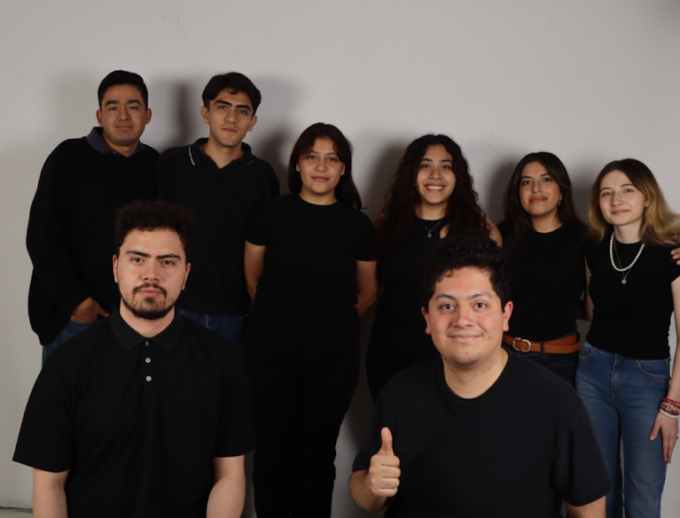 a group of people standing in front of a wall