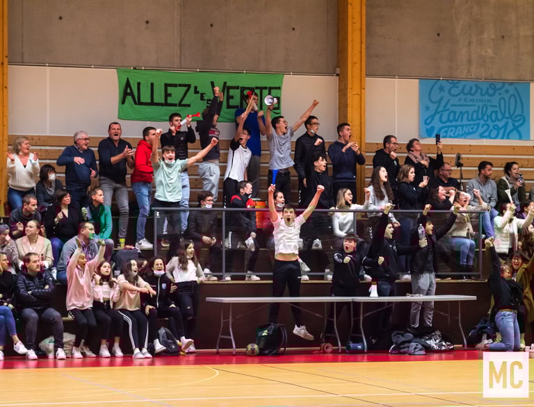 a group of people standing in front of a crowd of people