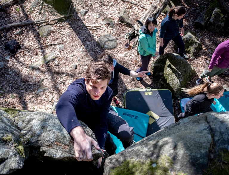 a man climbing a rock face down a steeple
