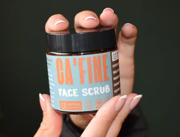 hands holding a cafine skincare product