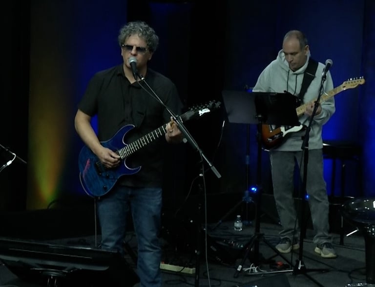 a band of musicians playing instruments on stage