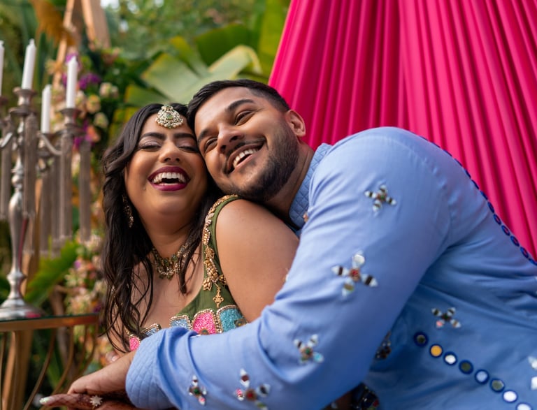 a man and woman in a colorful dress and a man in a blue suit