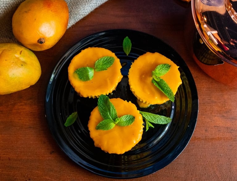 Mango lassi cheescake varnished with a mint leaf on top- plated