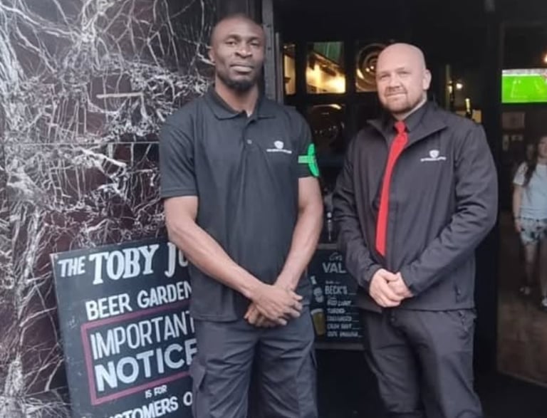 two security professionals outside of the venue