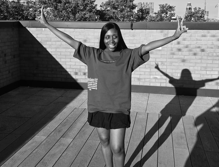 a woman standing on a deck with her arms up