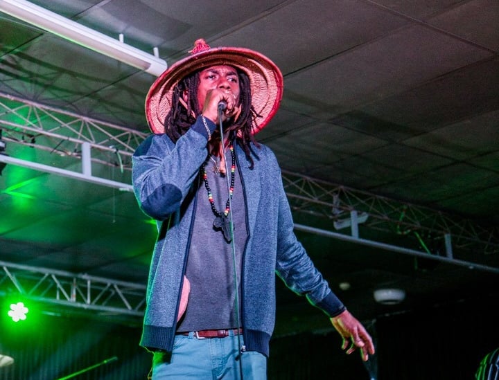 a man in a hat and a hat on stage