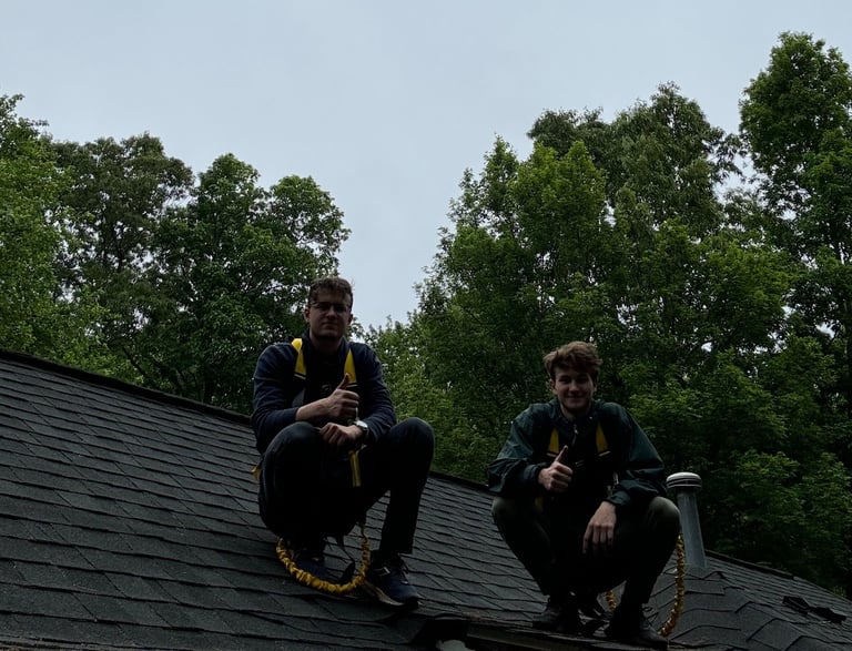 two men sitting on a roof top