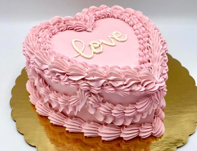 a pink heart shaped cake with a heart shaped cake