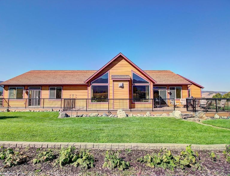 26205 sliding Horse Ln - Back of wood panelling house -Saddle Horn Custom Homes