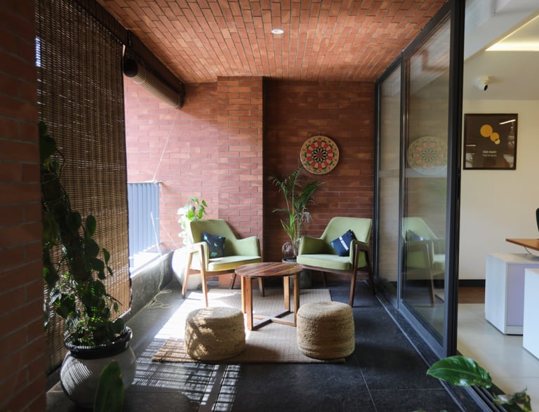 a living room with a couch and a chair- 371 workspace clayworks
