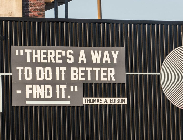 a sign that says "there's a way to do it better" a quote from Thomas A. Edison