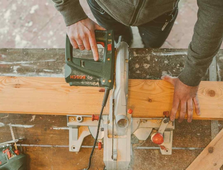 a man is using a circular sawdusted woodworking machine