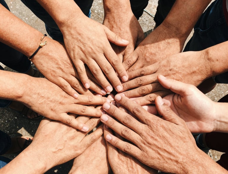 A friendly corporate meeting with people shaking hands in a bright office.