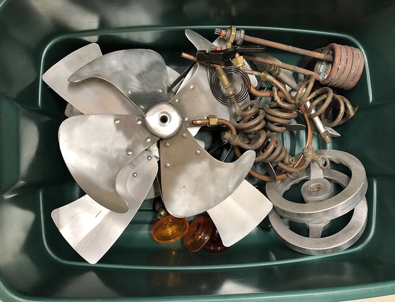 A sample of metal parts in a storage bin inside the Talbotics workshop.