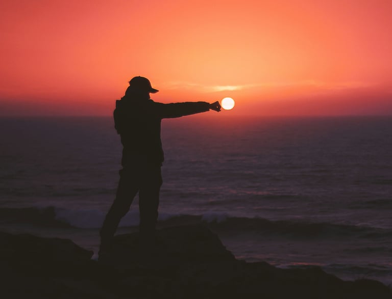 Abundance at the Ocean. A silhouette reaches out over the ocean during a glorious sunset.