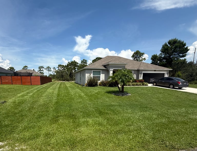 a house with a car parked in the grass
