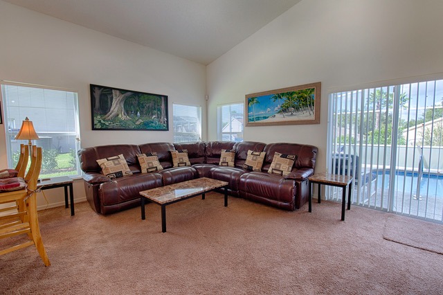 a living room with a leather couch and a table
