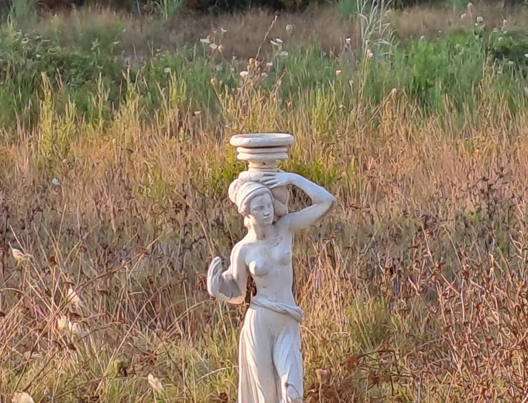 a statue of a woman with a bowl on her head