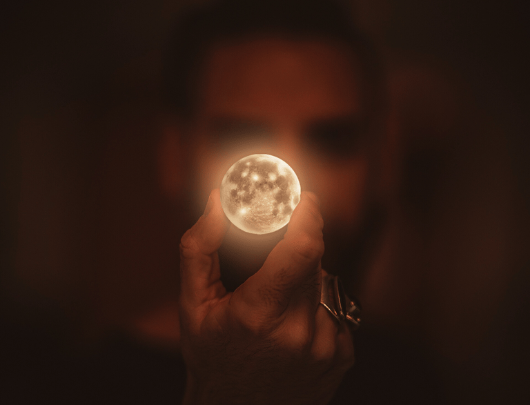 a person holding a light up in the dark