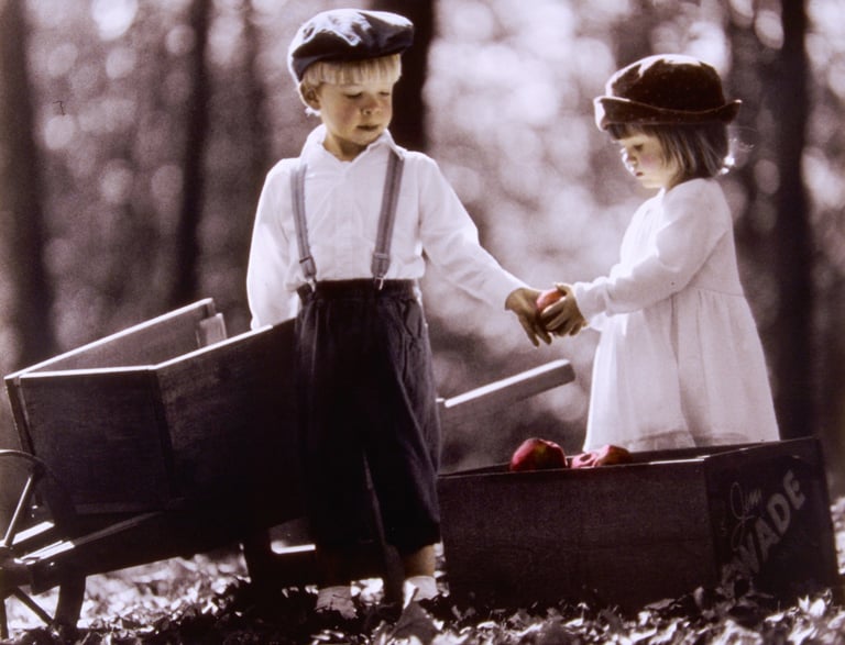 vintage photo of a boy and girl holding hands and holding apples