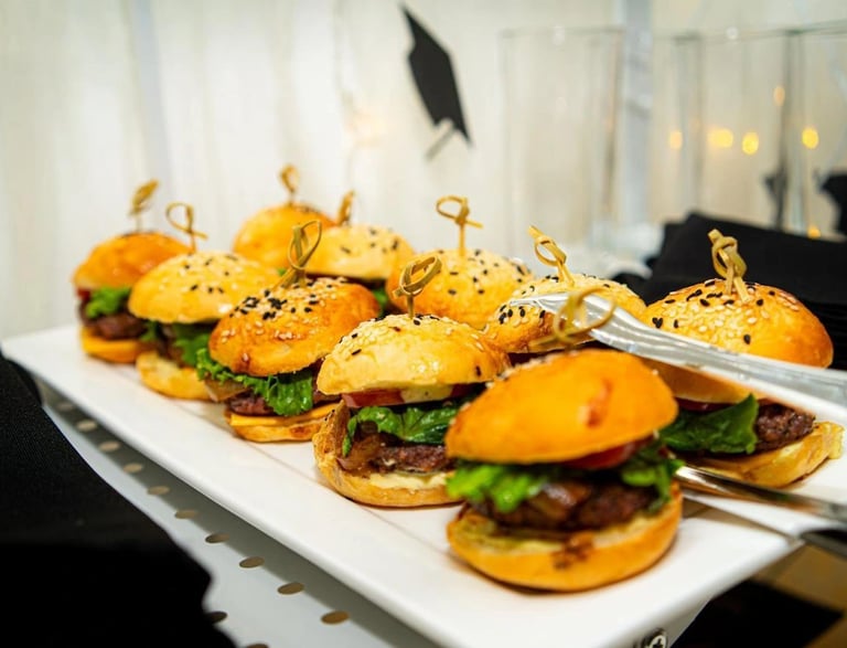 a plate of mini sandwiches with cheeseburger