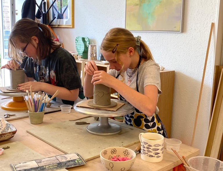 a woman is making a clay pottery pottery pottery pottery pottery pottery pottery pottery pottery pottery