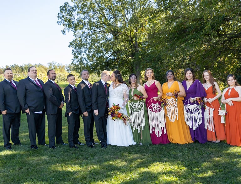 a group of people standing in front of a tree