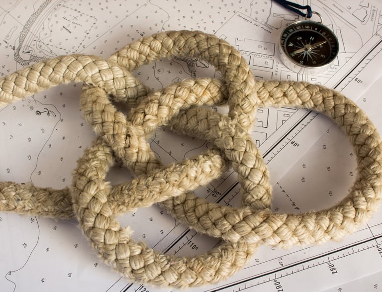 a nautical knot on a chart with a compass
