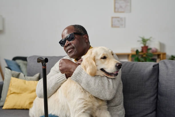 Man on couch hugging dog