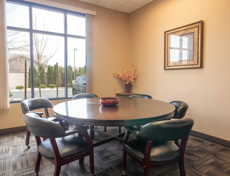 A conference room office table with a red bowl on it