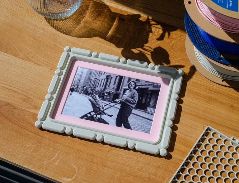     KOIJOY 3D printed frames displayed on a desk in a minimal interior setting