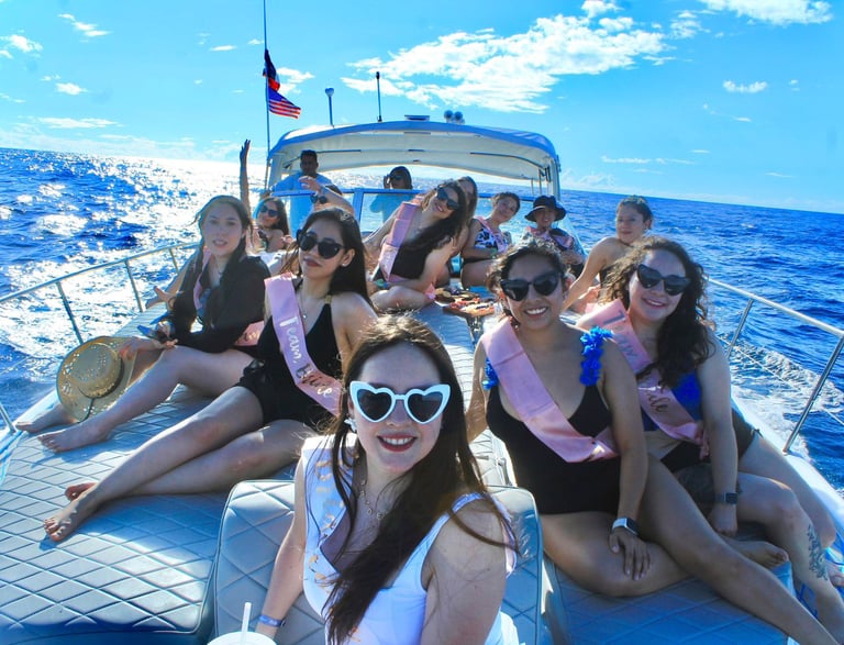 A group of women celebrating a bachelorette party on a private boat tour at sea.
