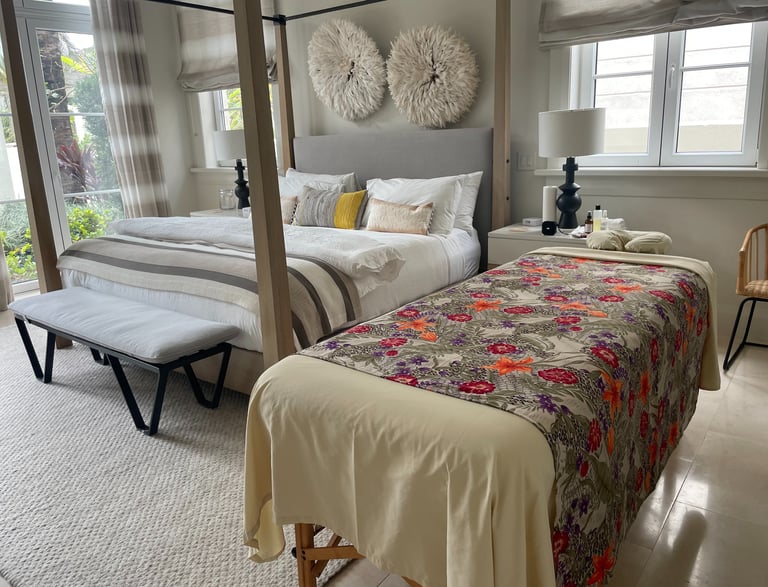 a bed with a canopy bed and a bench and a massages by sophia table