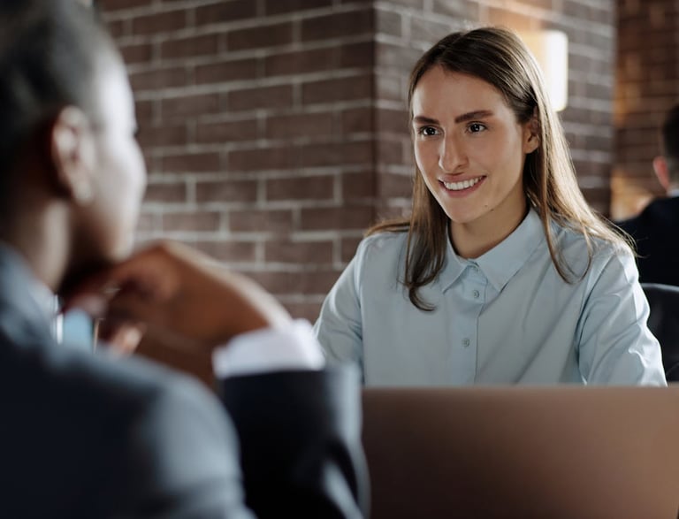 a woman in a blue shirt and a man in a suit and tie