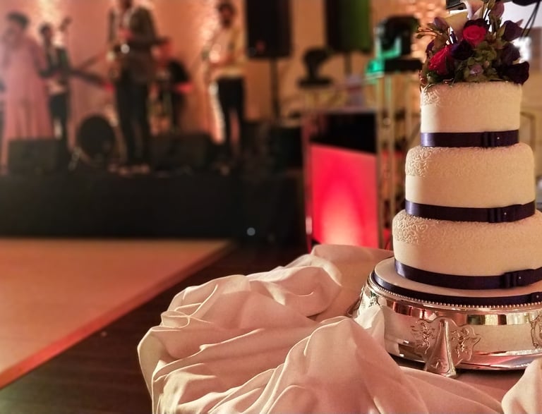 a wedding cake with a band playing on the stage